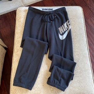 Nike sweat pants. Black with silver swoosh and silver sequin Nike logo Size M